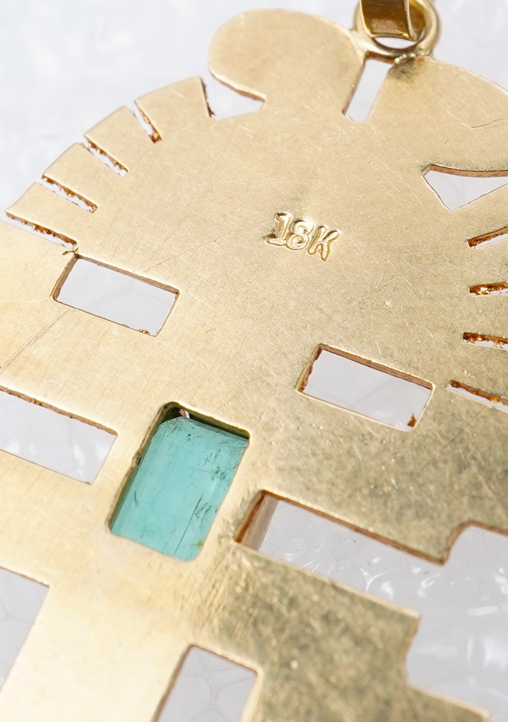 A collection of five gold pendants